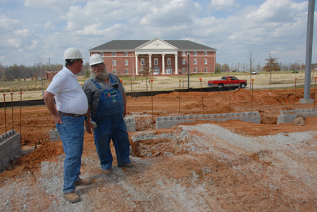 Workers discuss their next moves while laying the foundation for White Hall. - Photo by Morris Abernathy