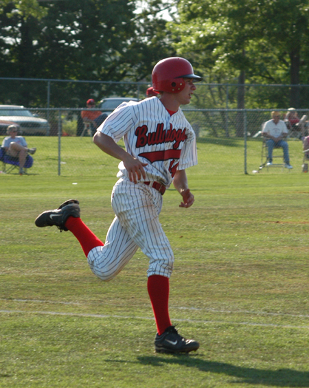 After a line drive single to center field, sophomore third baseman James Brasfield prepares to round first base. - Photo by Steven Aldridge