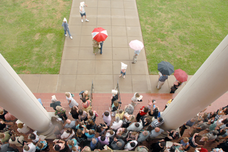 Crowds formed under the columns of Jennings Hall at graduation ceremonies after the start of a sudden rainstorm.  - Photo by Tim Weisemann