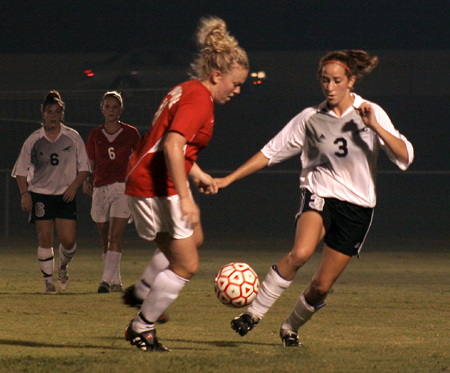 Freshman Cheslie Tharpe (red) fights for the ball against a Crichton College player. - Photo by Kyle Kurlick