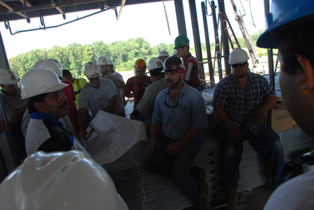 Workers make sure they're on the same page during the construction of White Hall. - Photo by Morris Abernathy