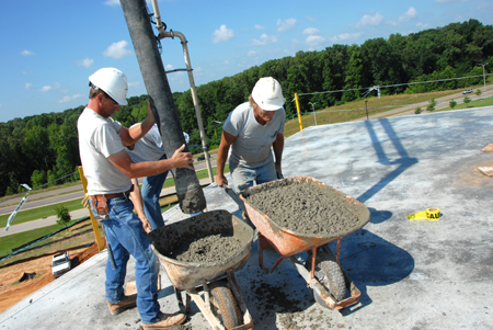 Workers prepare to lay concrete on the top of White Hall. - Photo by Morris Abernathy