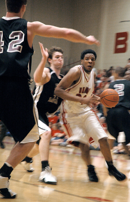 Junior forward Deywane Lee (white) drives to the basket in a game versus Freed-Hardeman University (Tenn.). - Photo by Kristen Nicole Sayres