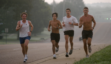 Douglas Martin, Phillip Thompson, John Fox, and Chris Arnold of the men's cross country team practice early in the morning in front of West Jackson Baptist Church, just outside of Union's campus. - Photo by Brad Moore