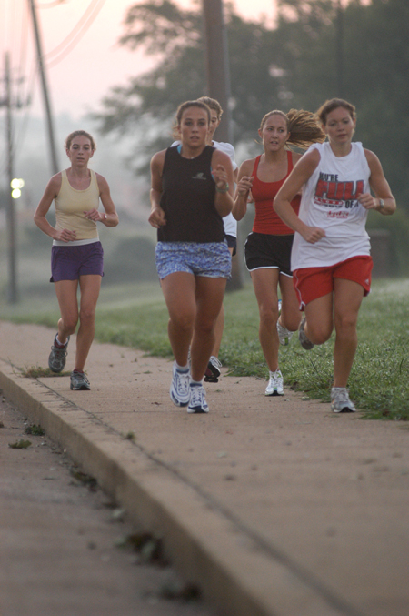 Charley Moss, Candace Cross, Lydia Bond, Rachel Winford and Jill Konkol of the women's cross country team practice in front of West Jackson Baptist Church, just outside of Union's campus. - Photo by Brad Moore