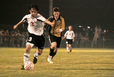 Freshman midfielder Cody Curtis (3), dribbles the ball downfield late in the game. - Photo by Kyle Kurlick