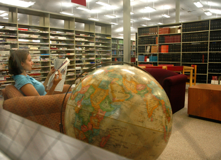 Katie Beth Kelley reads a newspaper while relaxing in the newly renovated Emma Waters Summar Library. - Photo by Kyle Kurlick
