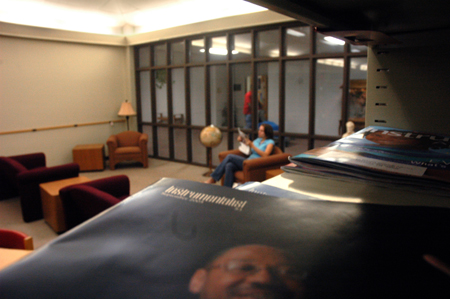 Katie Beth Kelley reads a newspaper while relaxing in the newly renovated Emma Waters Summar Library. - Photo by Kyle Kurlick