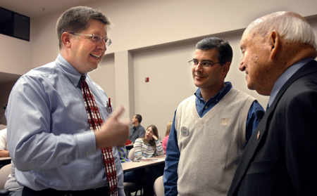 Ray Van Neste, associate professor of Christian studies, talks with Truett Cathy, founder of Chick-Fil-A, before his session with students in Harvey Hall. - Photo by Brad Moore