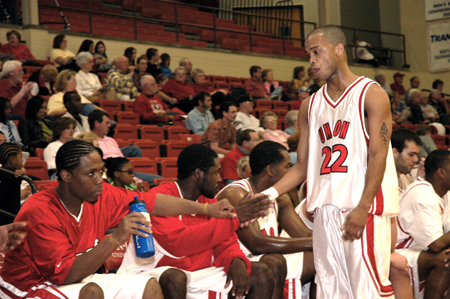 Senior guard Rod Ross (22) gets high-fives from teammates. - Photo by Brad Moore
