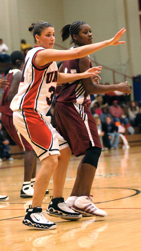 Union sophmore guard Merideth Richardson (white) plays tough defense in the game versus Southern Nazarene University (Okla.). - Photo by Brad Moore