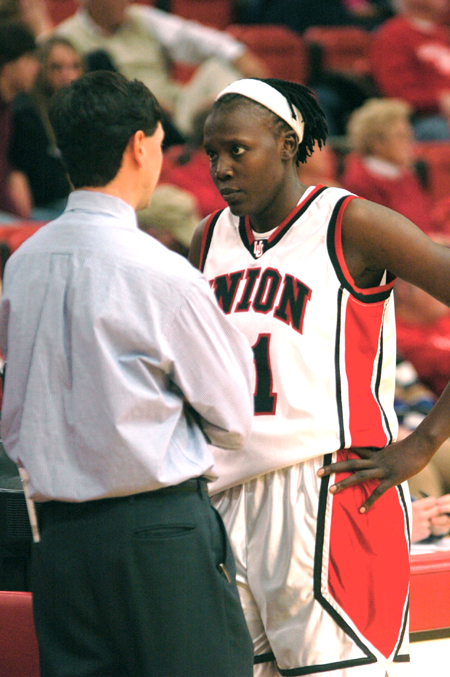 Freshman center Josephine Owino listens intently to Head coach Mark Campbell's instructions. - Photo by Brad Moore