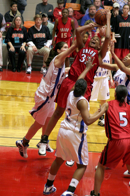 Natanya Smith takes a shot through lots of contact from Lubbock Christian University defenders.  Union won the game for their second straight NAIA National Title. - Photo by Steven Aldridge