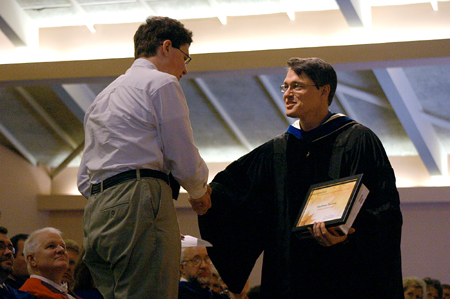 Troy Riggs, chair of the math department, presents Freshman Matthew Dawson with The Wolfram Award in Computational Science during Awards Day. - Photo by Stephanie Schroeder