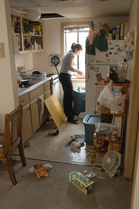 Junior Sarah Thompson from Arkadelphia, AR begins the process of cleaning up the damage in her kitchen as a result of the tornado that came through on Saturday night. - Photo by Jim Veneman