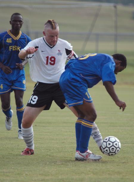 Junior Gareth Munro attempts to take the ball away from a Fisk University player.  The Bulldogs defeated Fisk in the game 9-0. - Photo by Holly Gushee