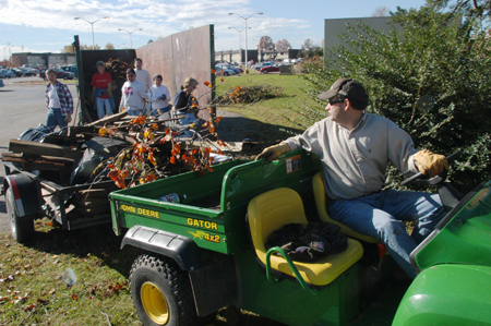 Athletic Training professor Robert Stiegmann drives a Gator around the residence life complexes to help haul off debris from the tornado. - Photo by Jim Veneman