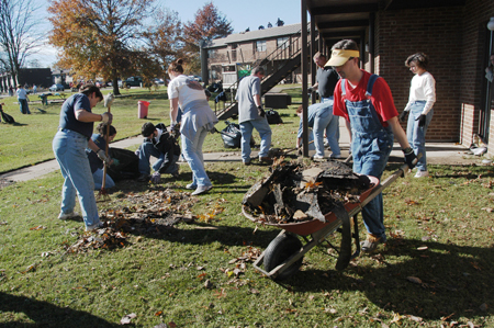 Director of Computing Services John David Barham helps cart off the mass of debris blown off of residence life complexes by the tornado. - Photo by Jim Veneman
