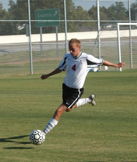 Colin Bonner, junior midfielder, kicks the ball downfield to waiting teammates. - Photo by Steven Aldridge