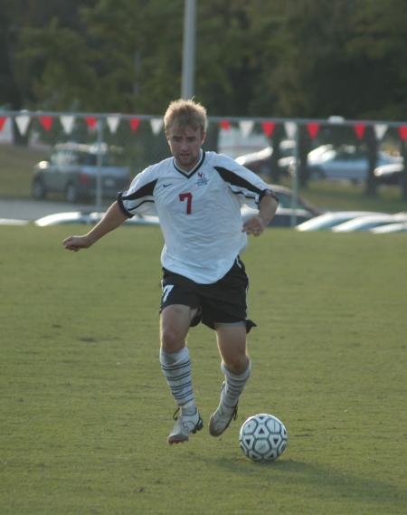 Senior forward Craig Clark dribbles the ball downfield. - Photo by Steven Aldridge