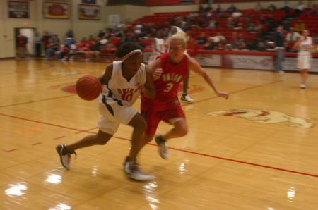 Senior Ena Daniels drives the ball down court while trying to avoid Junior Crystal Eason during a Bulldog Madness scrimmage. - Photo by Stephanie Schroeder