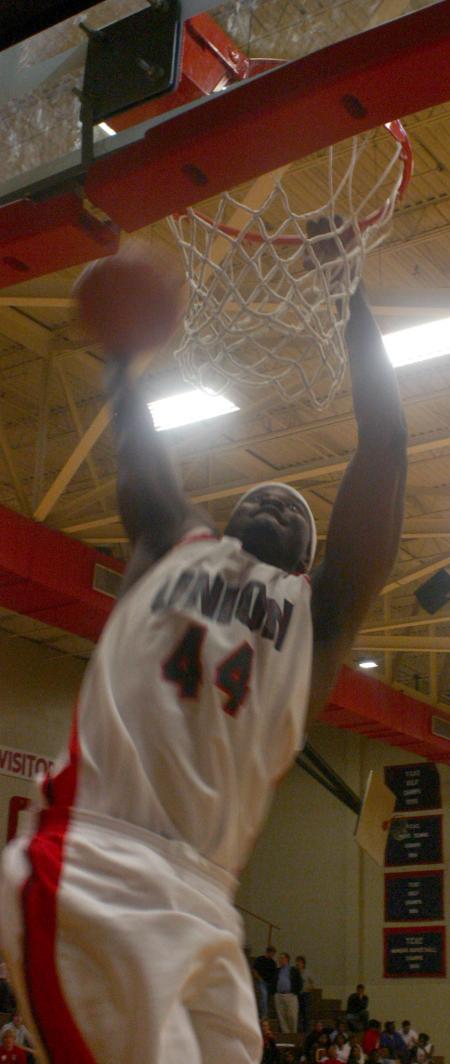 Senior Pierry Valmera slams a basketball during a dunk contest the night of Bulldog Madness. Valmera won the judges over. - Photo by Stephanie Schroeder