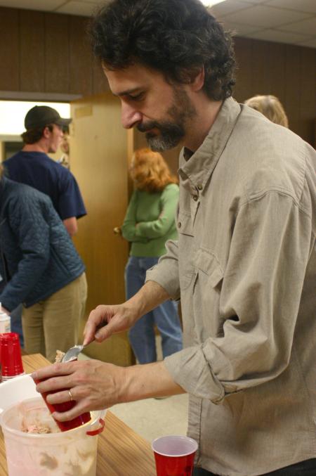 Tim Lowly, a guest artist from Chicago, serves himself ice cream for dessert during the art retreat. - Photo by Stephanie Schroeder