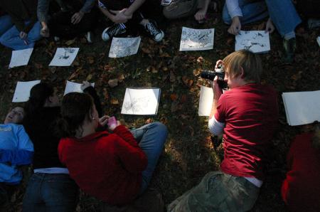 Drew Winter takes a picture of other students participating in a drawing project outside during the art retreat. - Photo by Stephanie Schroeder