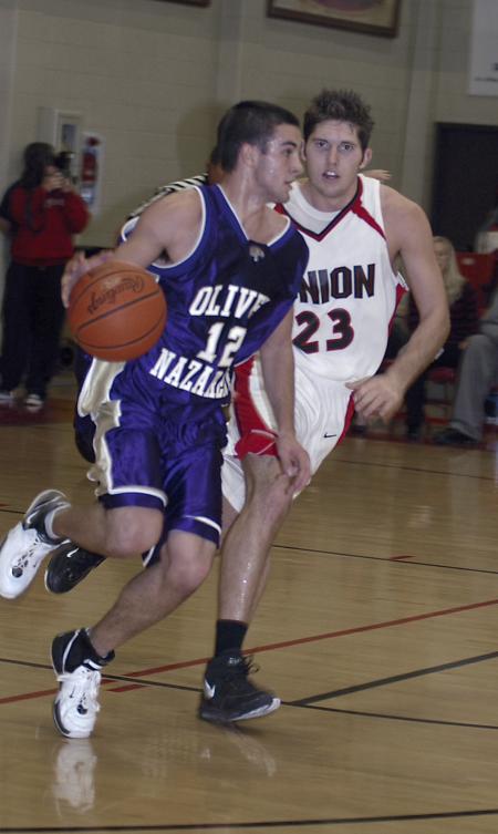 Junior Ryan Merriman guards an Olivet Nazarene player during Union's 83-65 win on Homecoming. - Photo by Holly Gushee