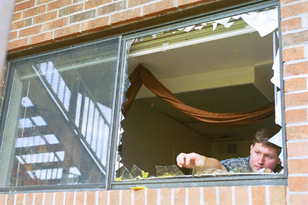 Union graduate Davie Moore volunteered his time to help clean up and restore windows in buildings on
campus that had suffered tornado damage. - Photo by Justin Veneman