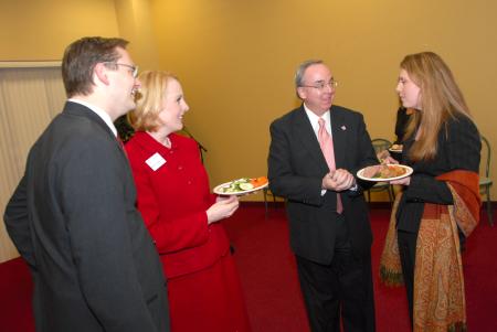 Greg and Kimberly Thornbury and President Dockery speak with Andrea Leigh McDaniel, who was honored as the Outstanding Young Achiever during the Homecoming Alumni Awards Dinner. - Photo by Morris Abernathy