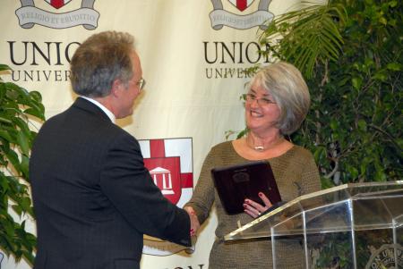 Jimmy H. Davis was presented with Distinguished Faculty/Staff Award by Judy Fletcher at the Alumni Awards Dinner during Homecoming. - Photo by Morris Abernathy