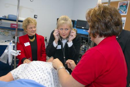 Julie Patterson (center), nursing administrative assistant, gets a first hand look at the nurse anethesia equipment during the Homecoming reception.  Assisting her is nursing faculty Pat Keene (left) and Pamela Binns-Turner (right). - Photo by Morris Abernathy