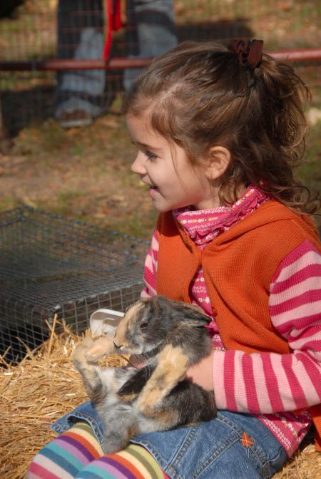 A future Unionite enjoys some rabbit interaction time at the petting zoo during the Arts in the Park event at Homecoming. - Photo by Morris Abernathy