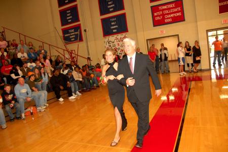 Sophomore Heather Childers, English literature major from Simpsonville, Ky., who is the daughter of Randall and Cindy Childers, is escorted onto the court by her watchcare father before the naming of the queen during Homecoming. - Photo by Morris Abernathy