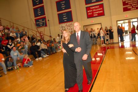Junior Carolyn Negley, learning foundations major from Brentwood, Tenn., who is the daughter of John and Jean Negley, is escorted onto the court by her father before the naming of the queen during Homecoming. - Photo by Morris Abernathy