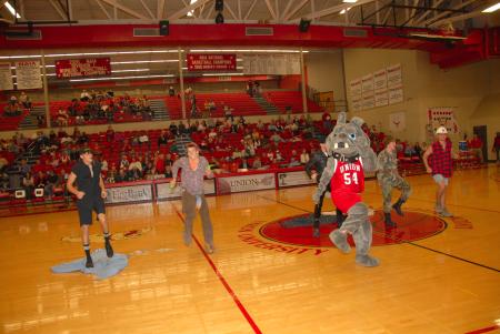 Buster and a Village People tribute group lead the Homecoming game crowd in YMCA. - Photo by Morris Abernathy