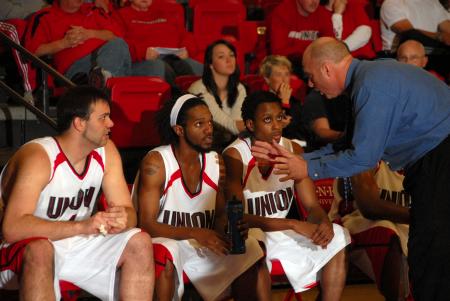 Head Coach Ralph Turner addresses his players on the bench. - Photo by Morris Abernathy