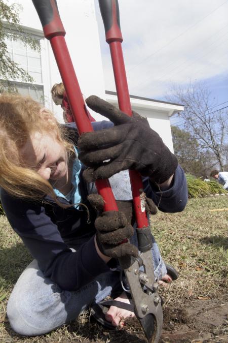 Lily Zopfi weeds out a walkway at The Care Center during Day of Remembrance. - Photo by Kyle Kurlick