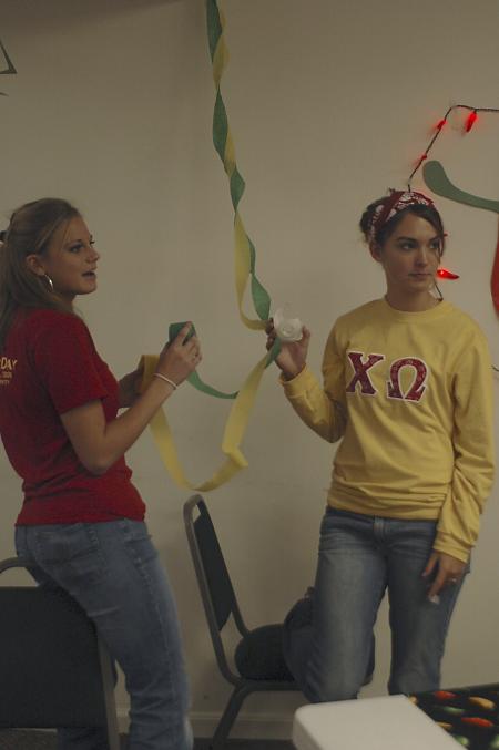 Freshmen Bethany Anderson and Chanel Watson decorate Evangelical Community Church in Jackson on the Day of Remembrance. - Photo by Holly Gushee
