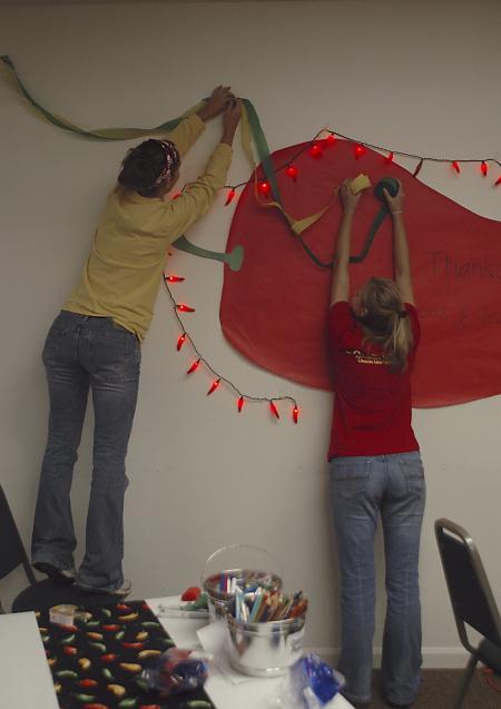 Freshmen Bethany Anderson and Chanel Watson decorate Evangelical Community Church in Jackson on the Day of Remembrance. - Photo by Holly Gushee