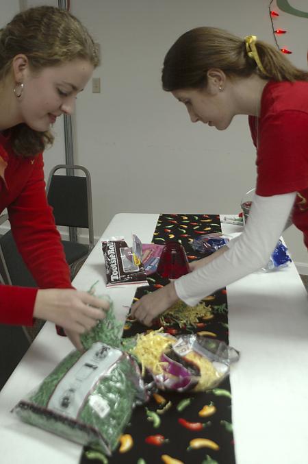 Freshmen Alison Turner and Deborah Lowe make decorations for Evangelical Community Church in Jackson on the Day of Remembrance. - Photo by Holly Gushee