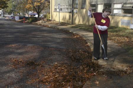 Freshman Sara Beth Woodbury helps out at Alexander Magnet Elementary School by raking tons of leaves on the school property during Day of Remembrance. - Photo by Stephanie Schroeder