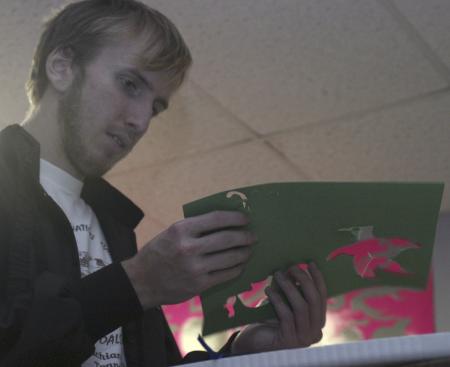 Sophomore John Henson punches out paper animals to help decorate one of the classrooms of Iglesia Bautista Hispania Church located at Poplar Heights Baptist Church during Day of Remembrance. - Photo by Stephanie Schroeder