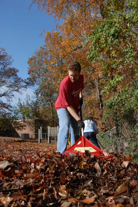 Matt Sengstock cleans up the playground at the YMCA during Day of Remembrance. - Photo by Morris Abernathy