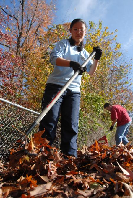 Jasmine Huang cleans up the playground at the Jackson YMCA during Day of Remembrance. - Photo by Kyle Kurlick