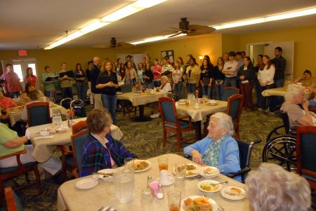 Richard Joiner and his choral students sing at The Oaks Nursing Home on Day of Remembrance. The residents joined in singing with the students. - Photo by Morris Abernathy
