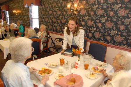 Junior Mattie Trautman fellowships with residents at The Oaks Nursing Home on Day of Remembrance. - Photo by Morris Abernathy