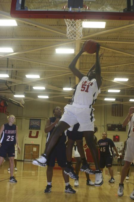 Sophomore Josephine Owino grabs a rebound during the Homecoming game against St. Gregory's University, Okla. - Photo by Stephanie Schroeder