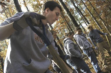 Ben Burleson, Jessie Miller, Nikki Henry, Camille McCullar and John Kay work together as a team to discover buried grave stones at the Ames Plantation during a Day of Remembrance project. - Photo by Matthew Diggs